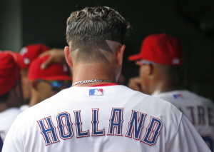 Texas Rangers starting pitcher Derek Holland (45) sports a unique hair cut as he prepares to pitch in the first inning of the Seattle Mariners vs. the Texas Rangers major league baseball game at Globe Life Park in Arlington on Wednesday, August 19, 2015. (Louis DeLuca/The Dallas Morning News)